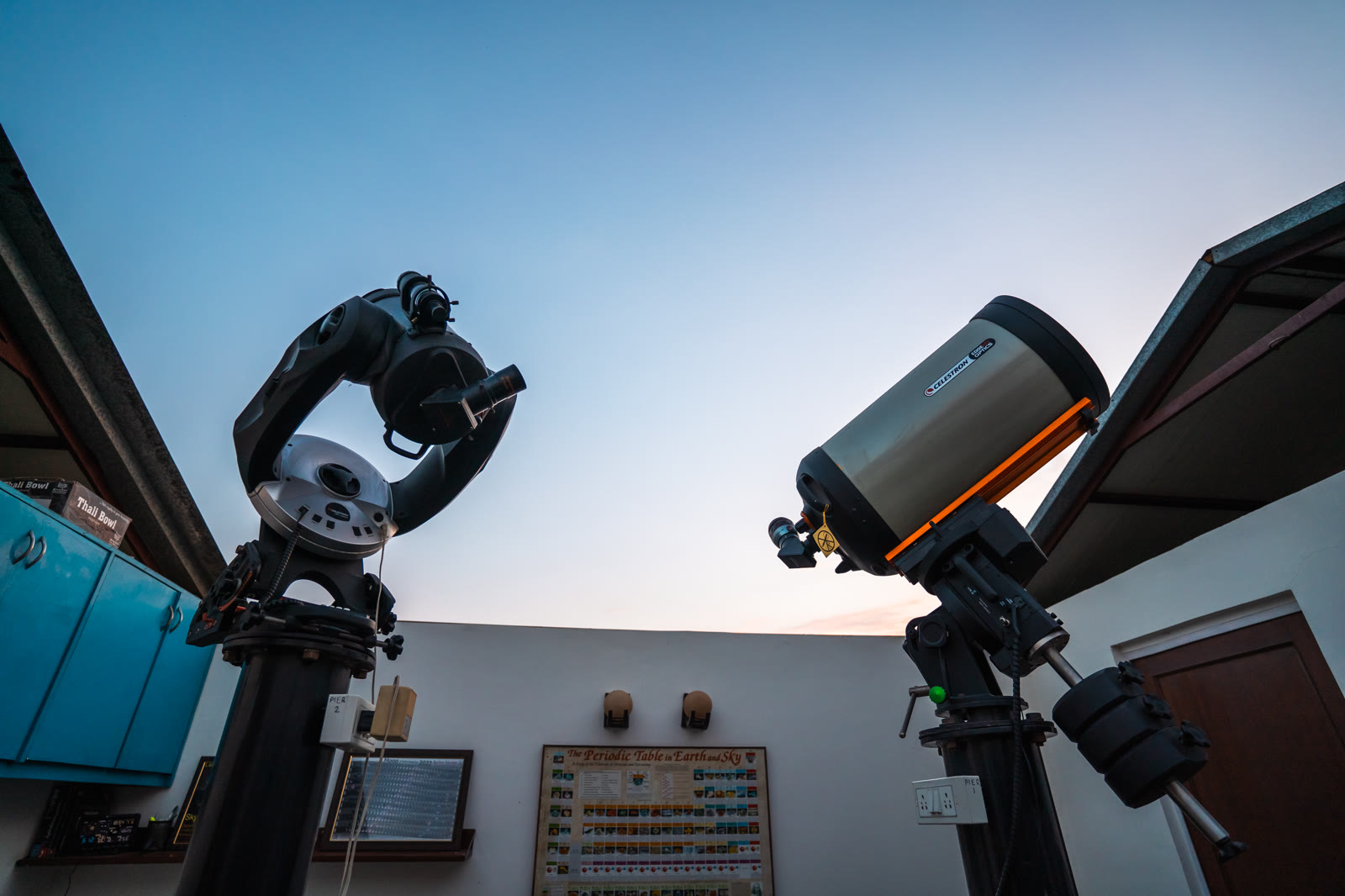 Two telescopes at TARA, the farm's observatory, at dusk